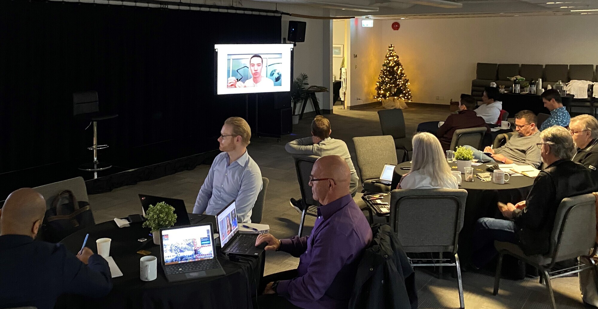 Group of people at board room watching a livestream