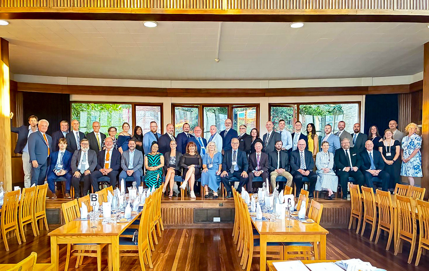 Group photo of Oxford Leadership Cohort Members and Instructors in a Formal Dining Hall